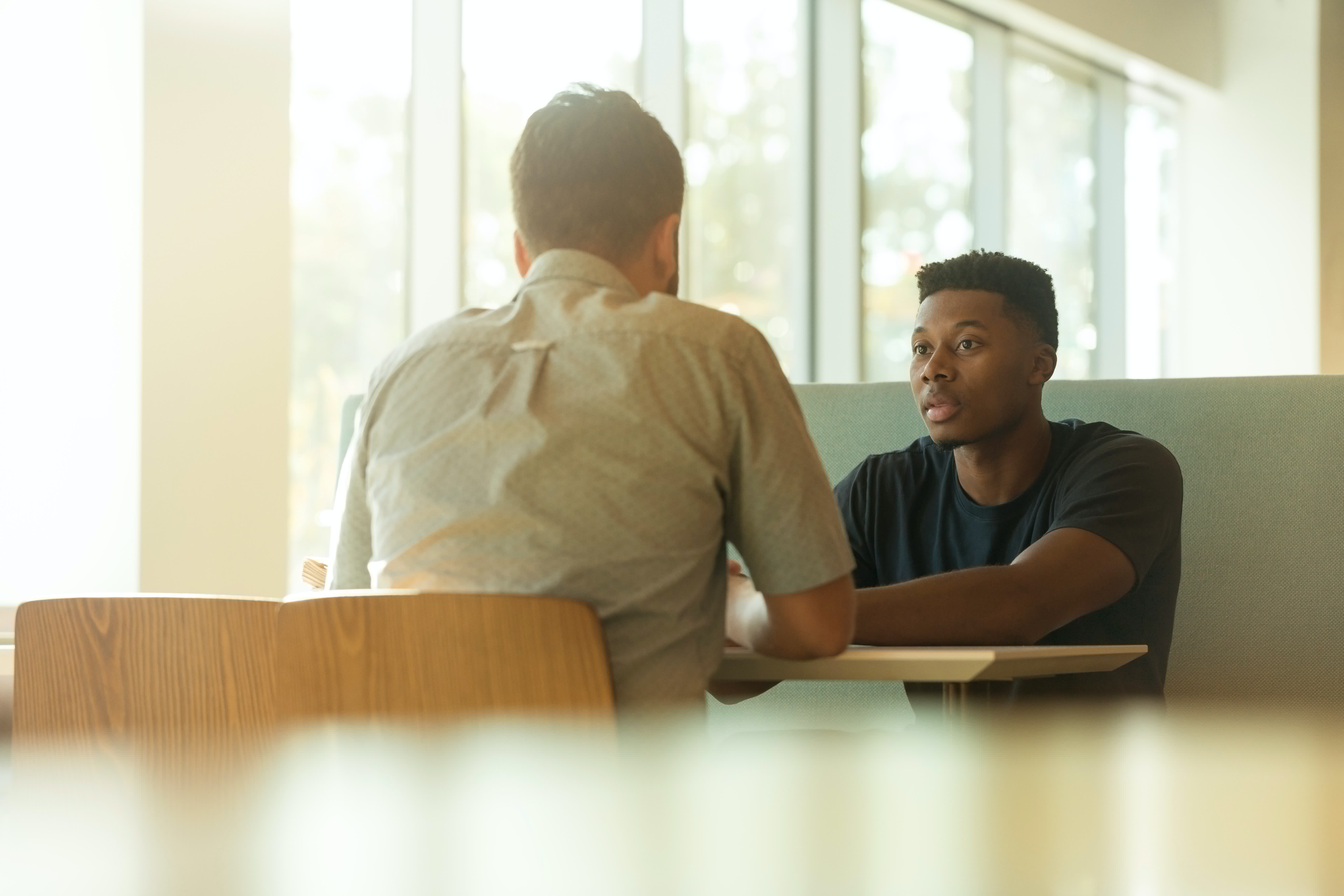 Young clinician chats to his clinical supervisor
