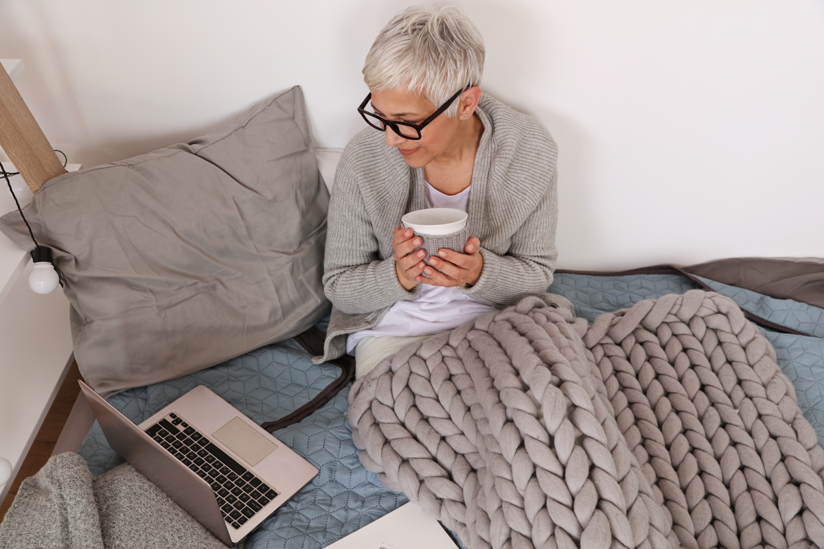 Lady reading a book in bed.
