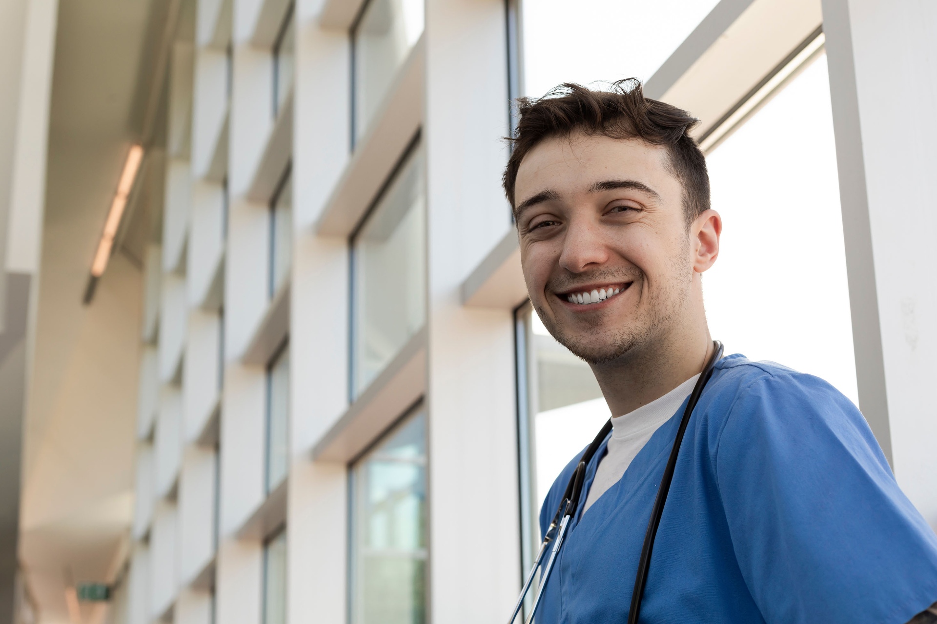 Smiling young nurse in scrubs