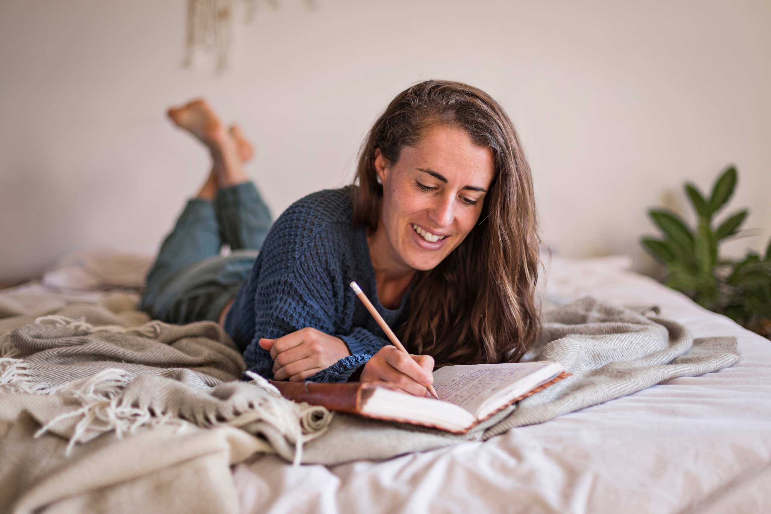 woman journalling in bed 