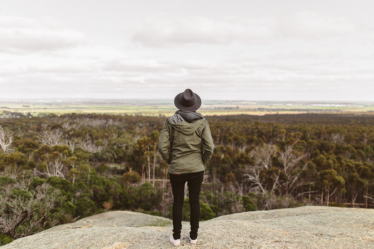 decorative image of woman looking out at a beautiful landscape