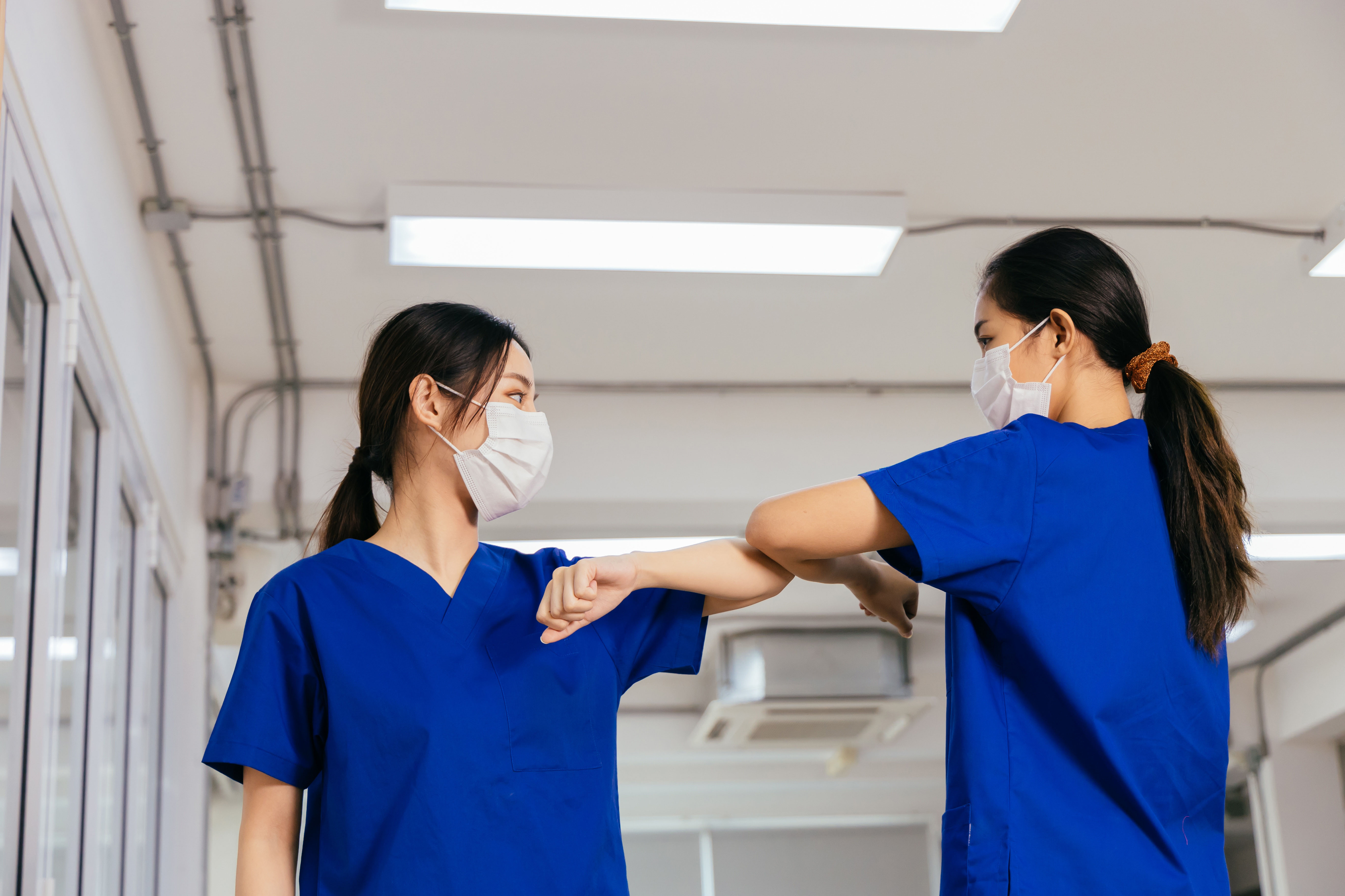 Masked midwives bump elbows