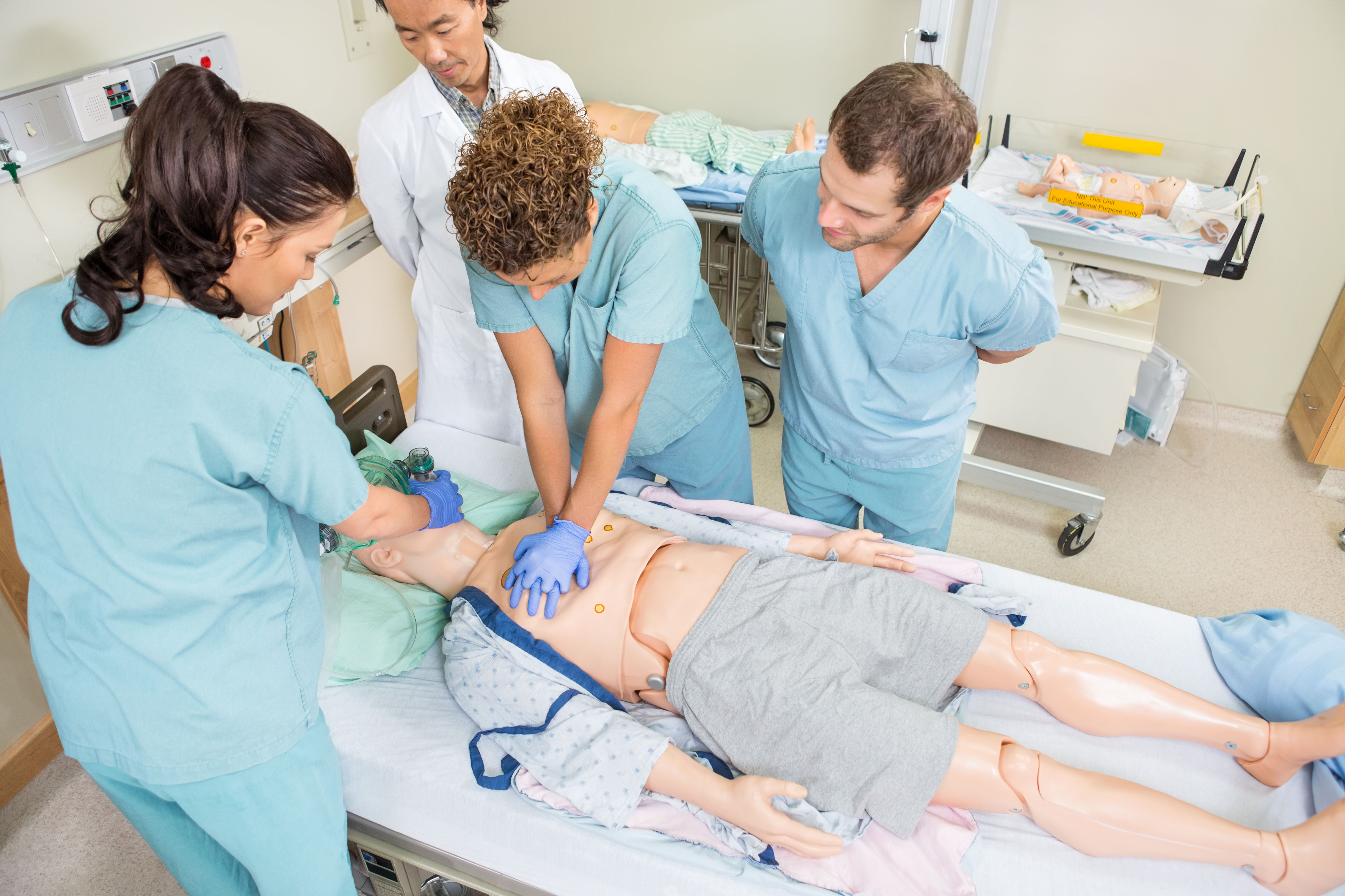 Students perform CPR on dummy